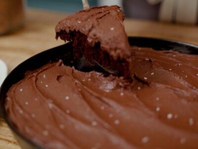 A slice of chocolate wacky cake on a serving utensil.