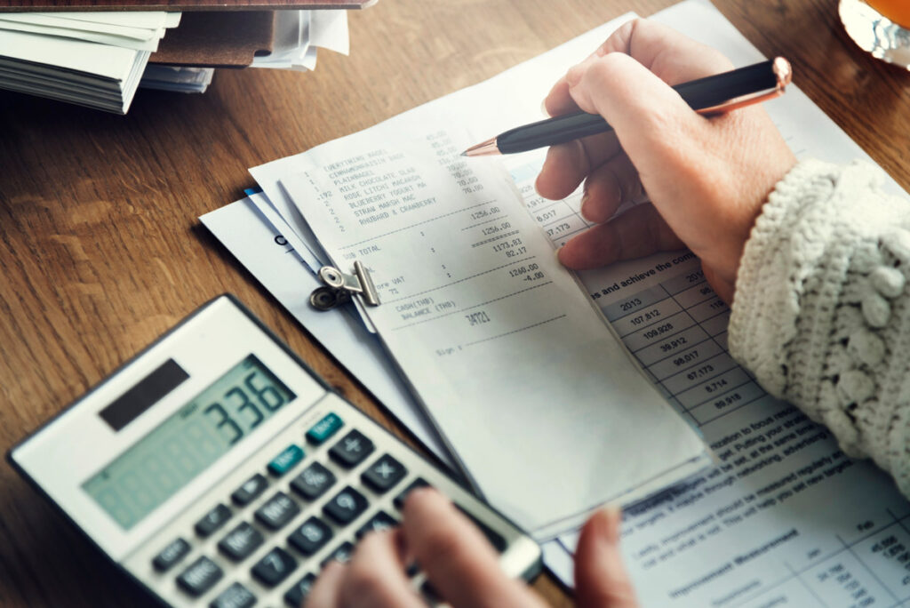 Receipts, a budget and a calculator on a desk.