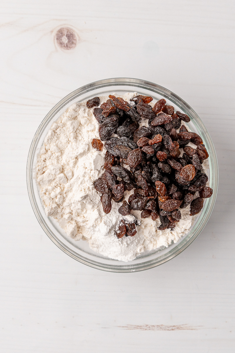Raisins in a bowl of flour.