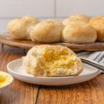 A dinner roll halved with melted butter.