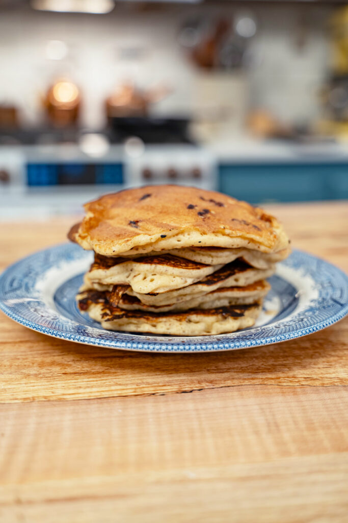 A stack of sourdough pancakes on a blue plate.