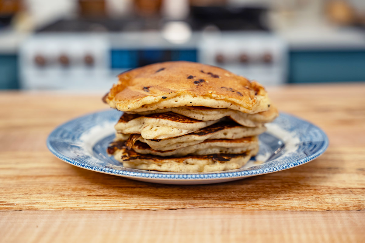 A stack of sourdough pancakes on a blue plate.
