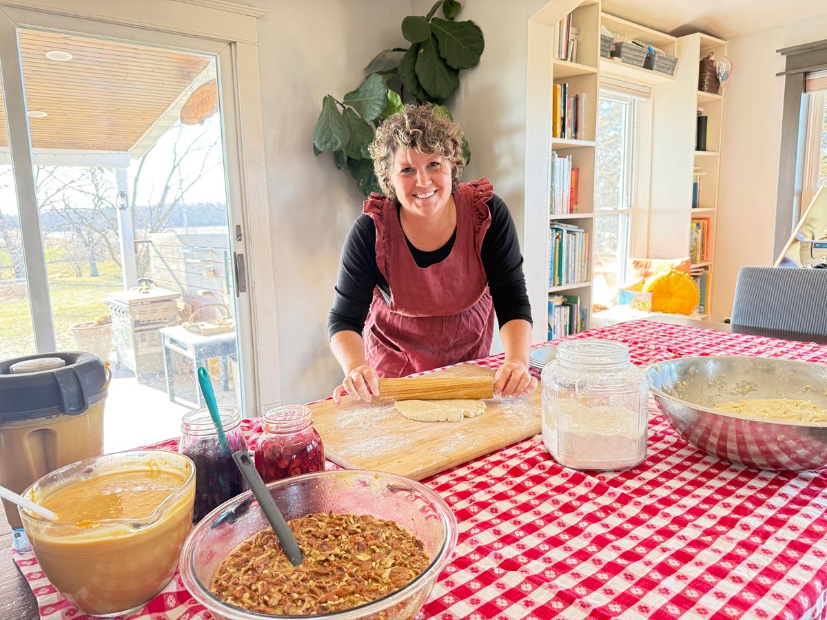 RuthAnn Zimmerman in her kitchen rolling out a pie crust.