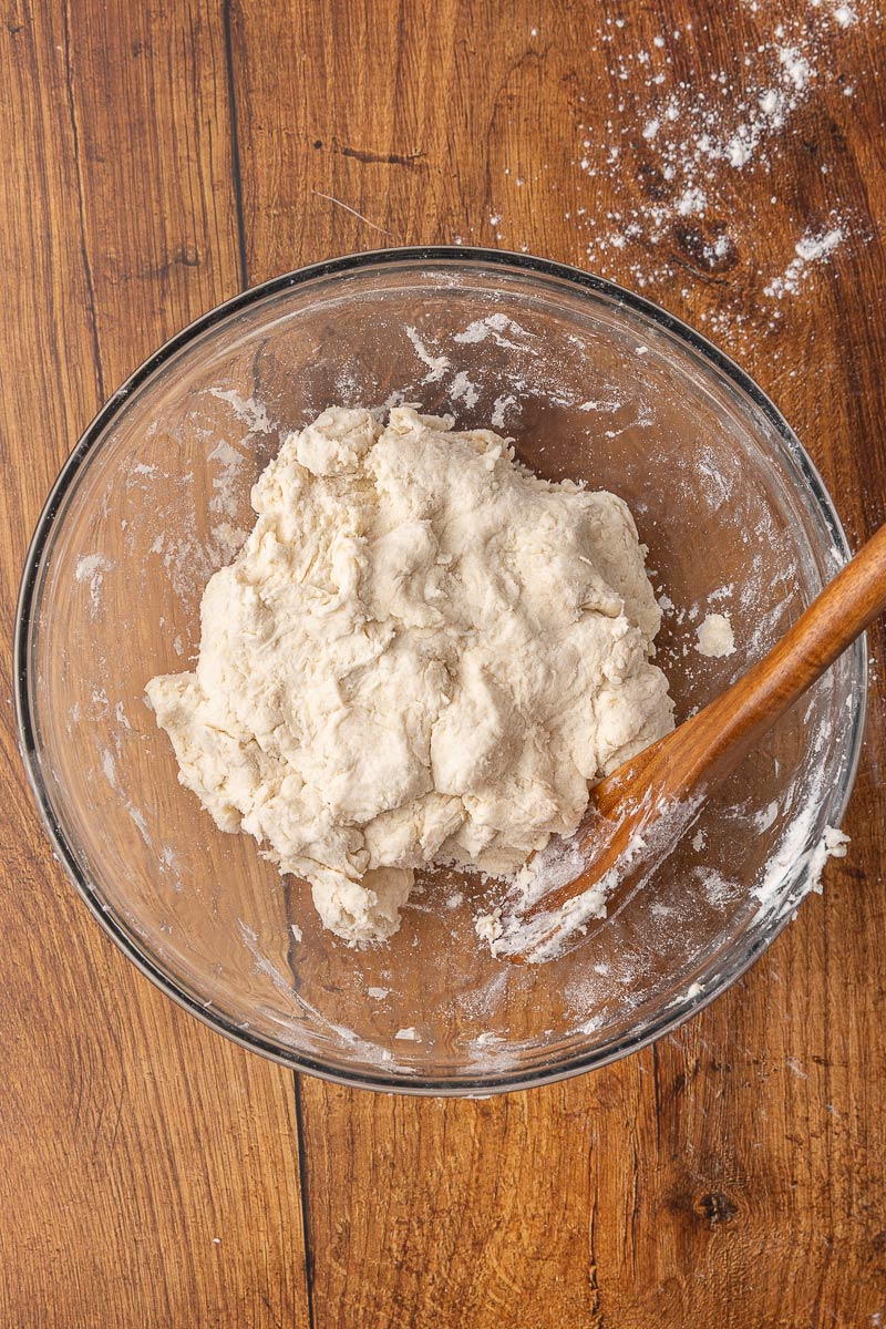 Biscuit dough mixed together in a glass bowl.