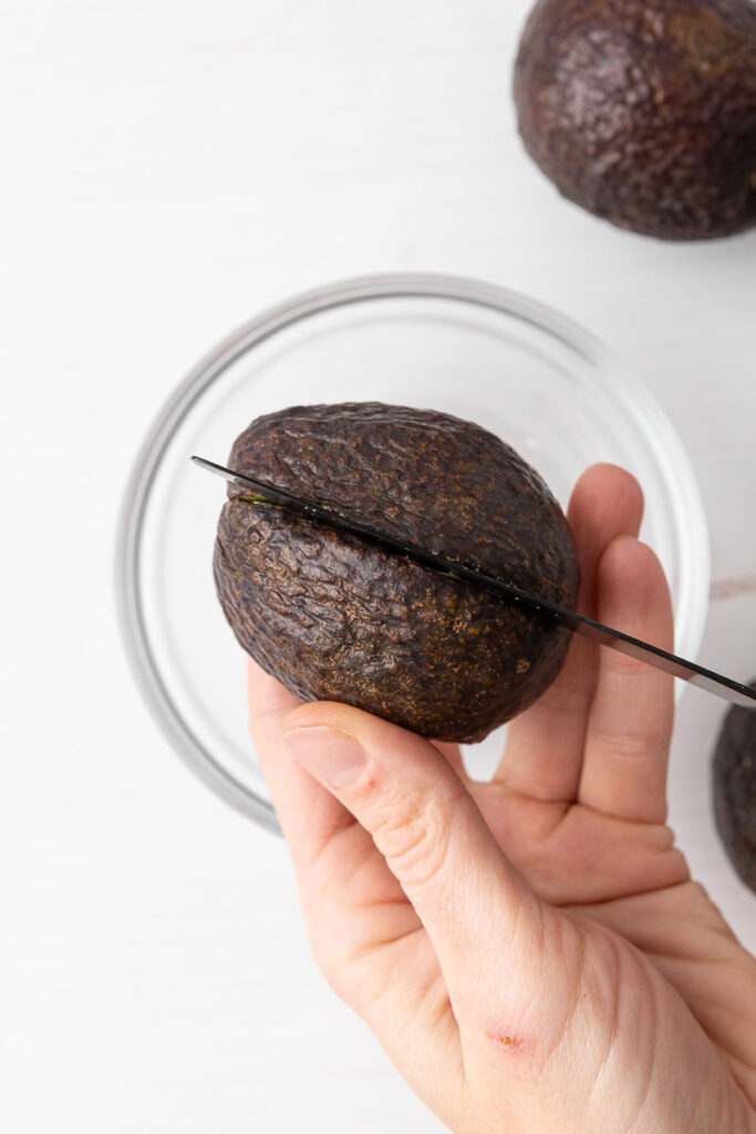 Slicing an avocado in half.
