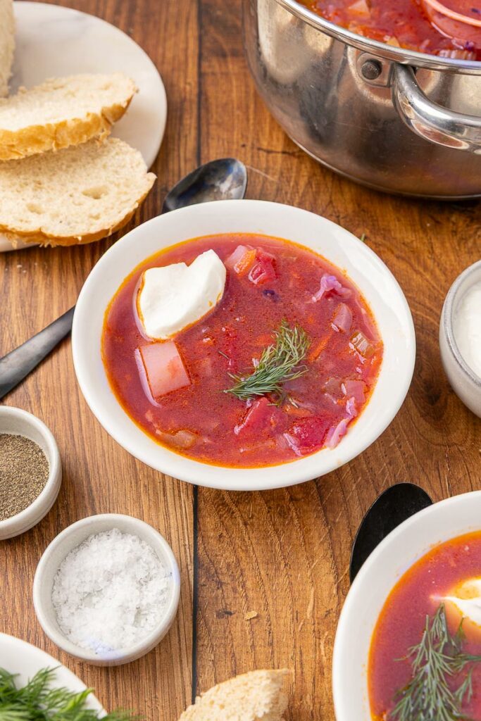 Bowl of traditional Ukranian borscht with slices of bread.