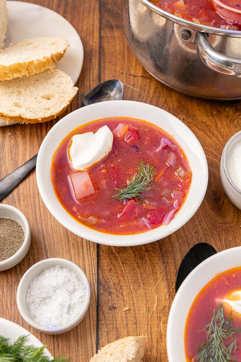 Bowl of traditional Ukranian borscht with slices of bread.