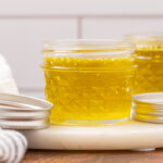 Finished herbal salve cooling in small jelly jars.