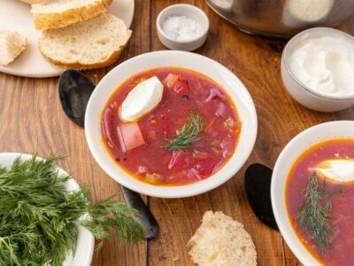 Bowl of traditional Ukranian borscht with slices of bread.