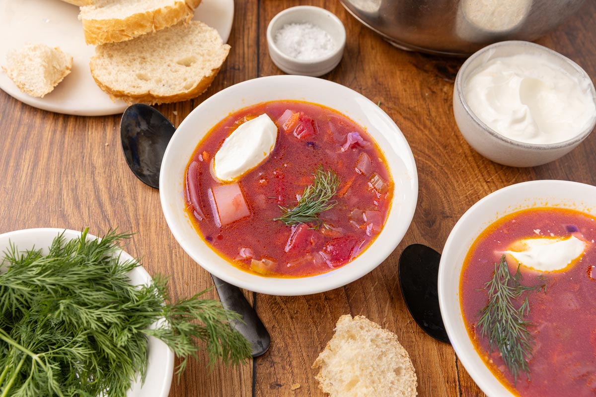 Bowl of traditional Ukranian borscht with slices of bread.