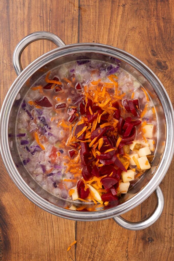 Ingredients for traditional Ukranian borscht in a stock pot ready to cook.