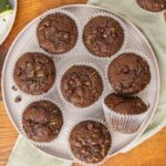 Baked double chocolate zucchini muffins on a serving tray.