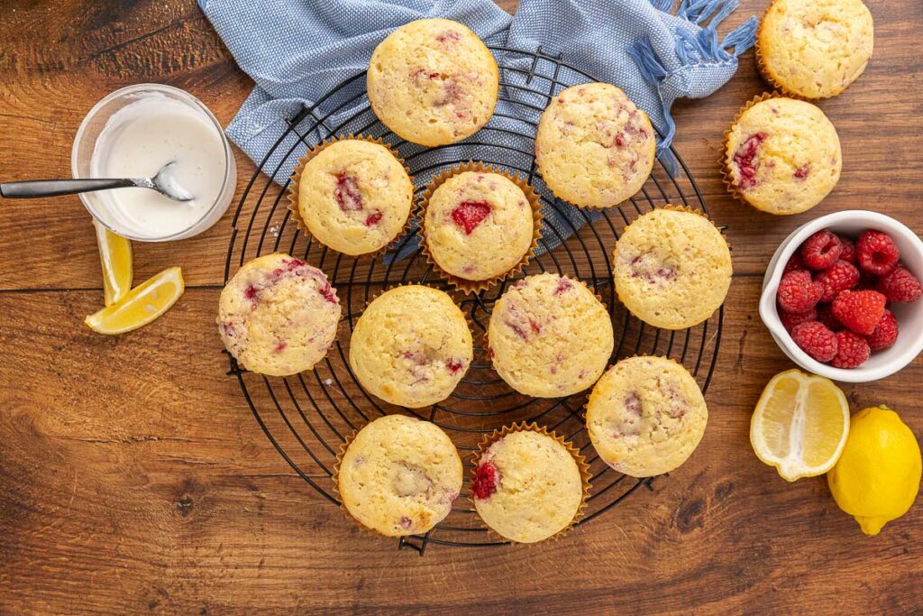 Baked raspberry cream cheese muffins on a cooling rack.