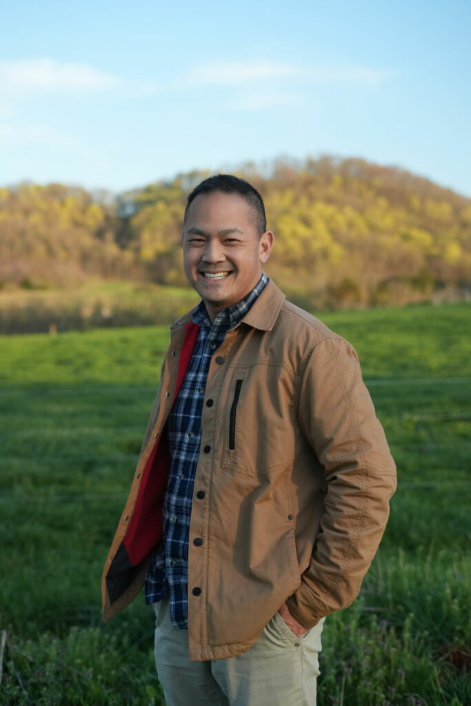A man standing in a green field.