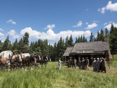People standing in front of an 1800s Land Office.