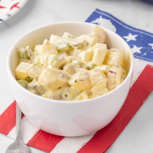 A white bowl filled with potato salad.