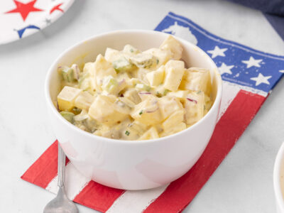 A white bowl filled with potato salad.