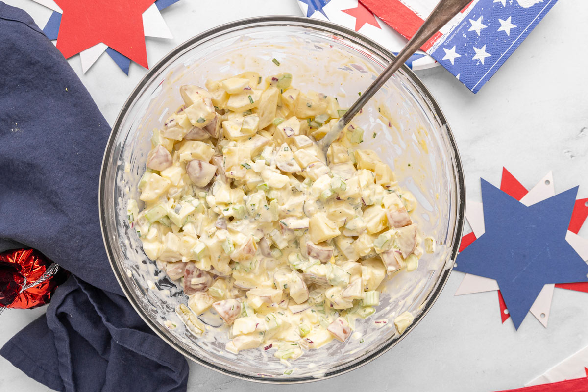 A serving bowl filled with creamy potato salad.