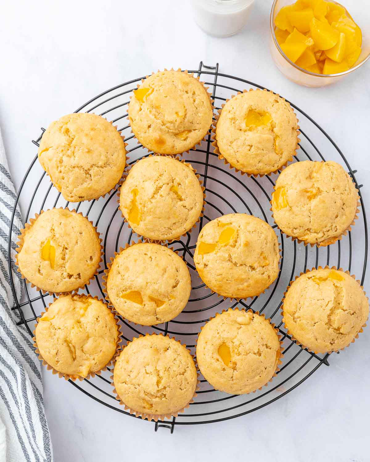 Freshly baked muffins cooling on a baking rack.