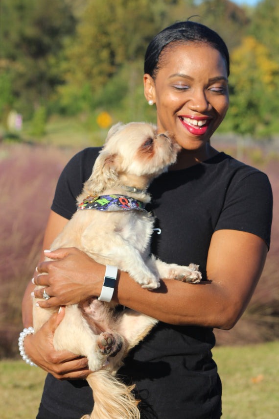 A woman holding a dog.