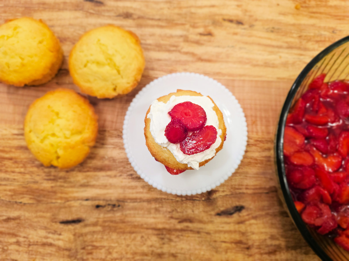 Assembled individual strawberry shortcake on a white plate.