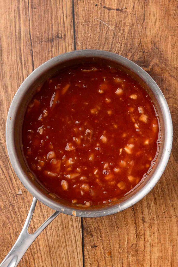 Homemade BBQ sauce boiling in a pot.