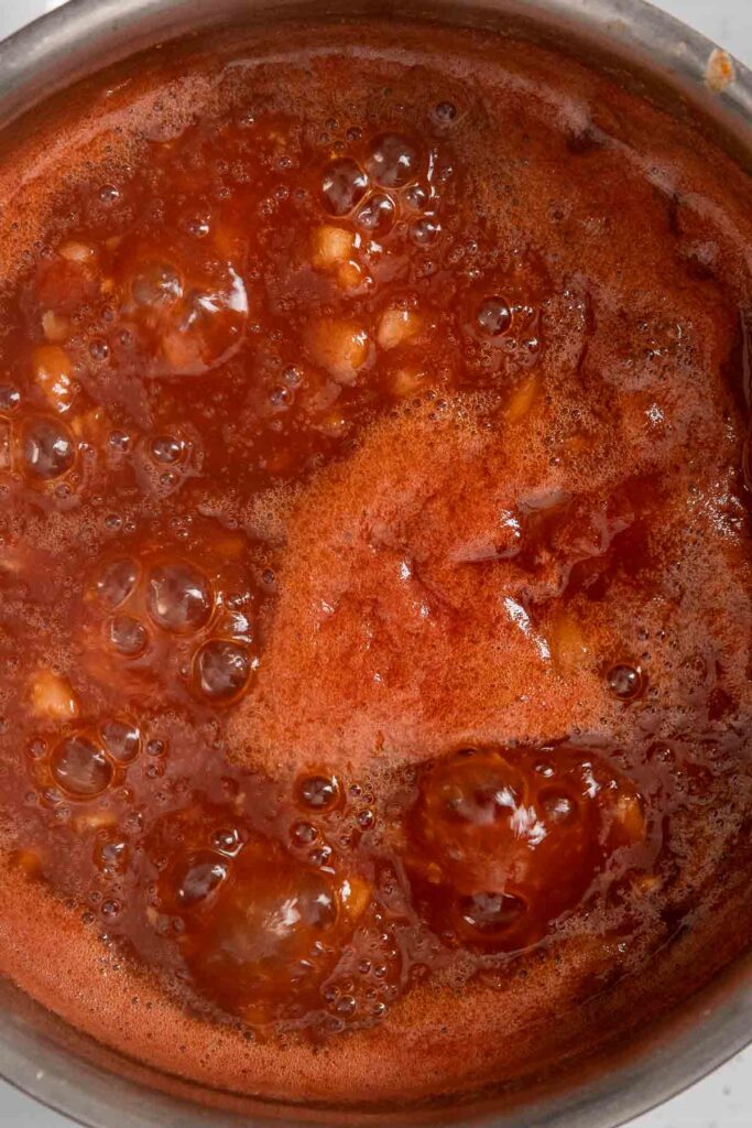 Homemade BBQ sauce boiling in a pot.