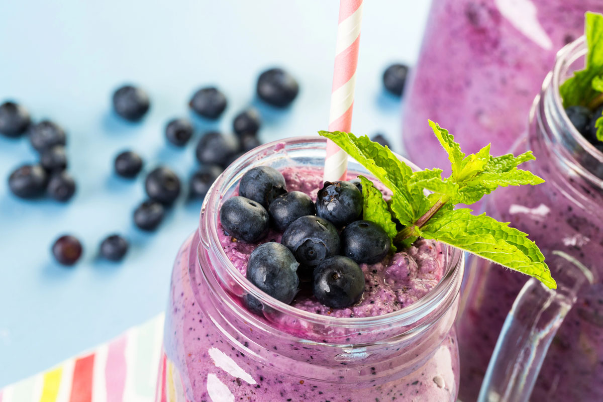 Blueberry smoothie in a glass cup.