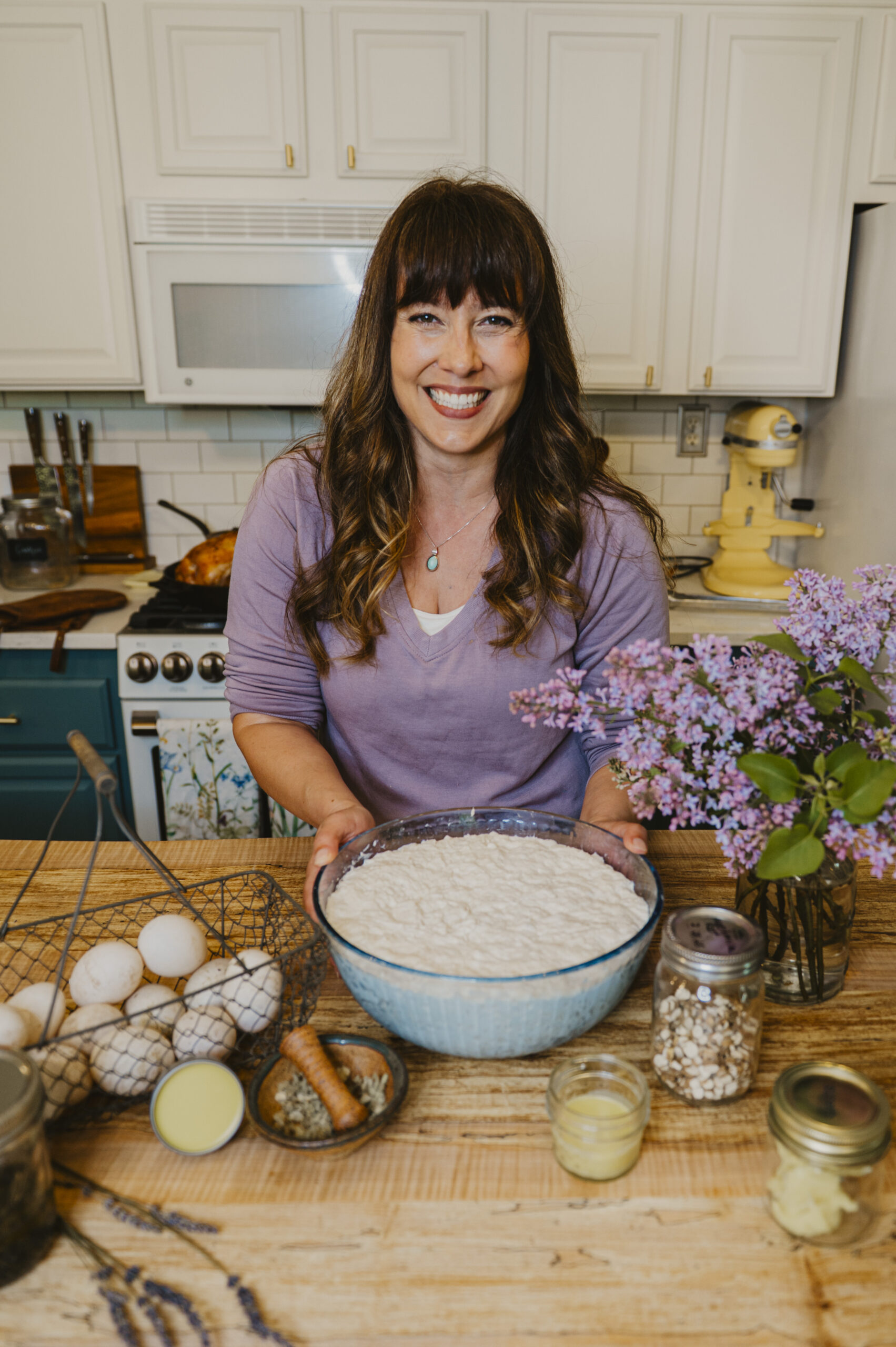 A woman in the kitchen making food.