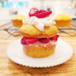Assembled individual strawberry shortcake on a white plate.