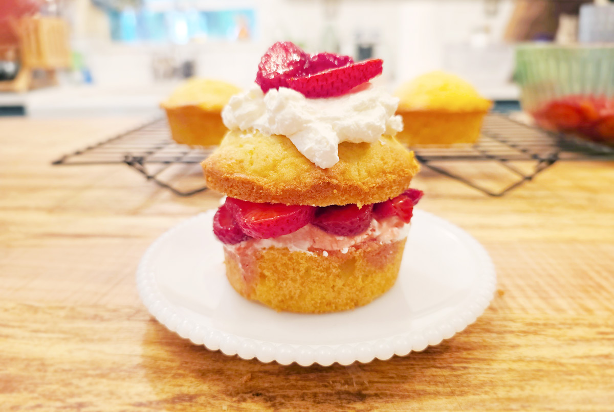 Assembled individual strawberry shortcake on a white plate.
