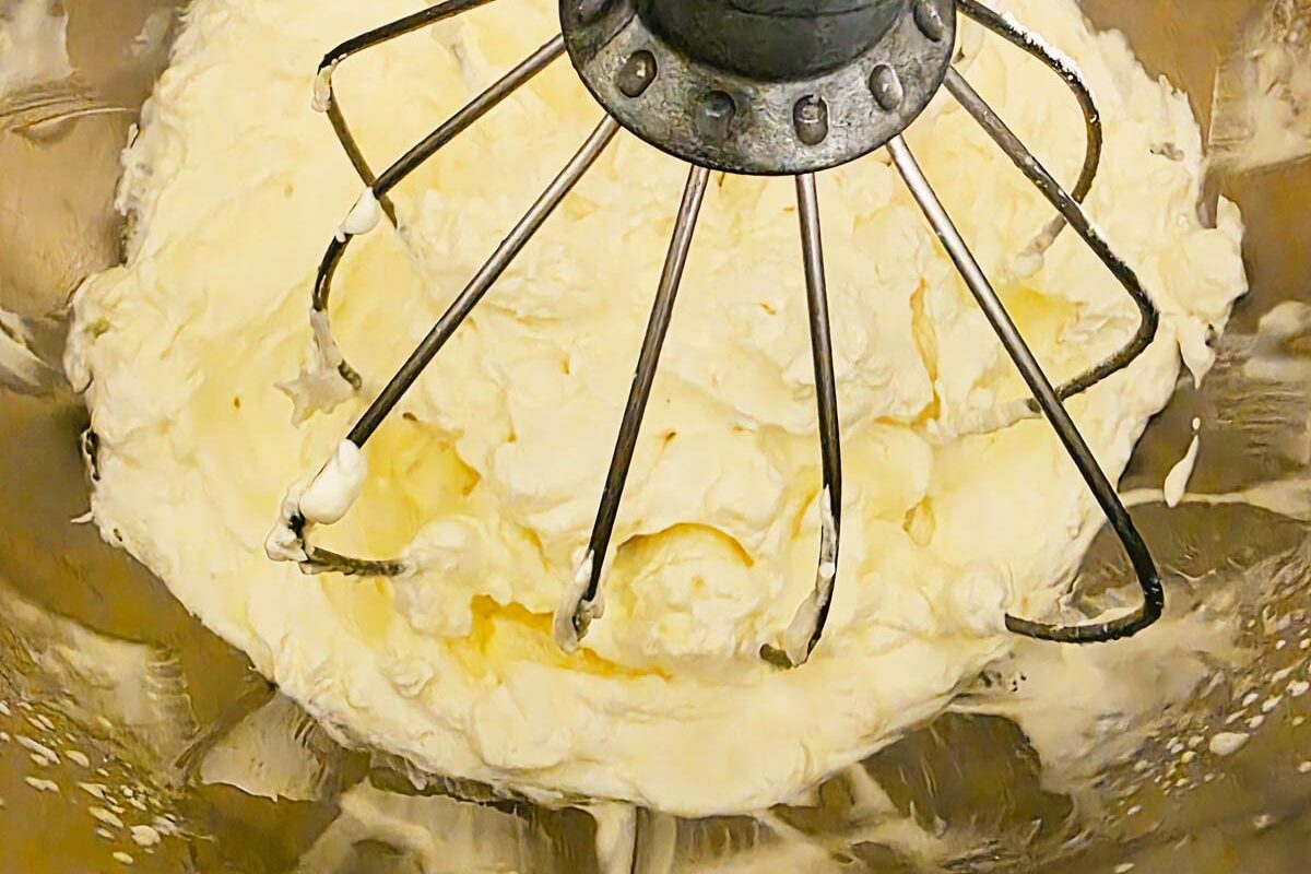 Whipped cream being made in a stand mixer.