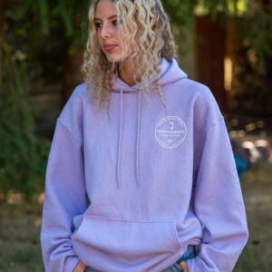 Woman in a lavender hoodie standing outside