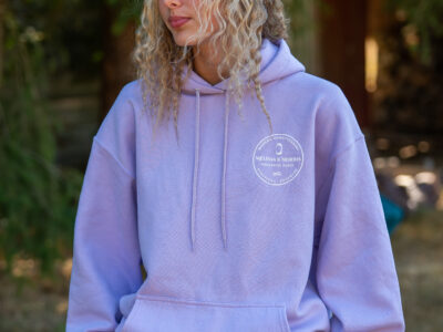 Woman in a lavender hoodie standing outside