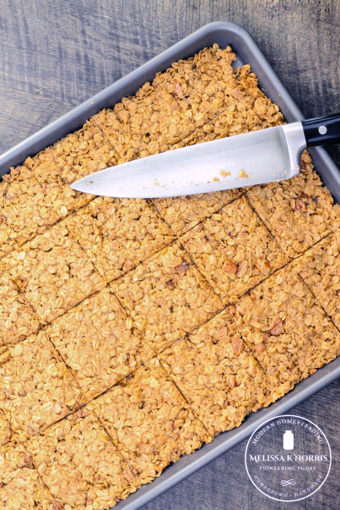Granola bars in a pan, scored into bars.