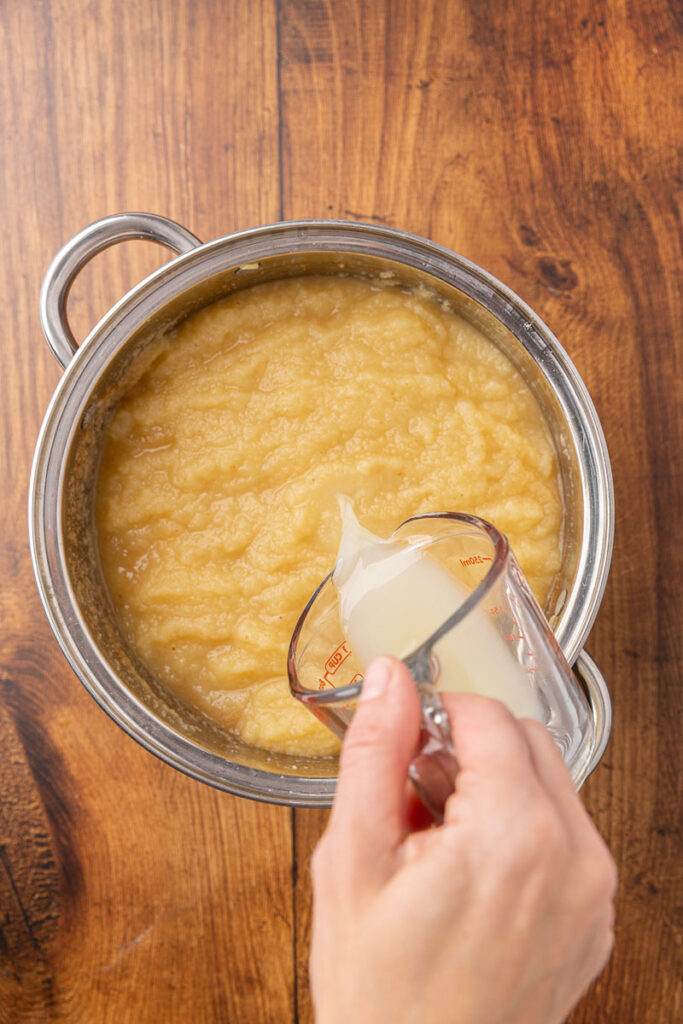 Adding lemon juice to applesauce.