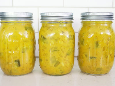 Jars of mustard pickles sitting on a counter.