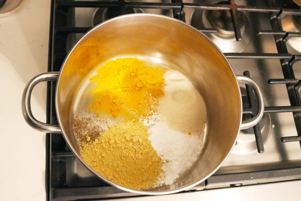 Spices and seasonings for mustard pickles in a pot.