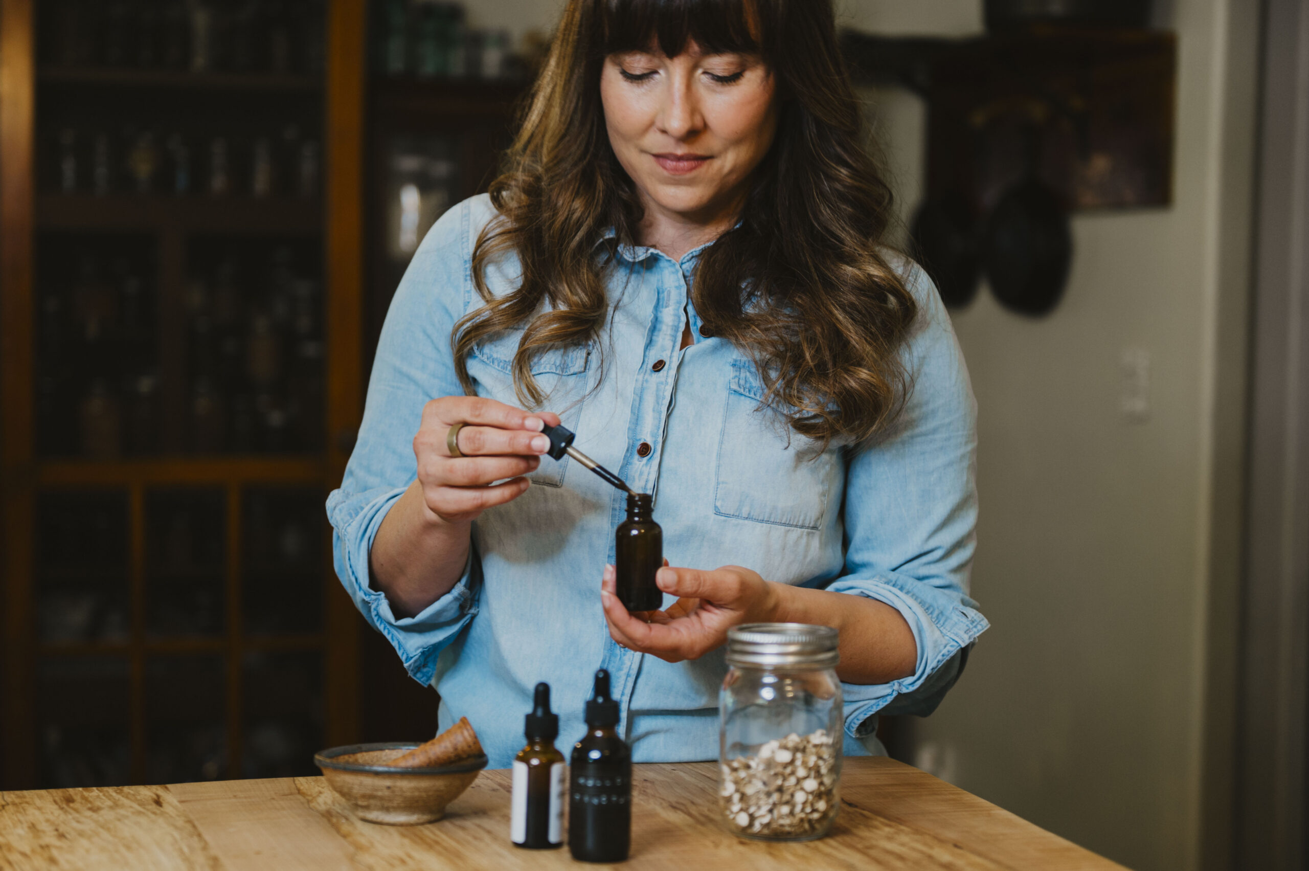 A woman with a tincture bottle.
