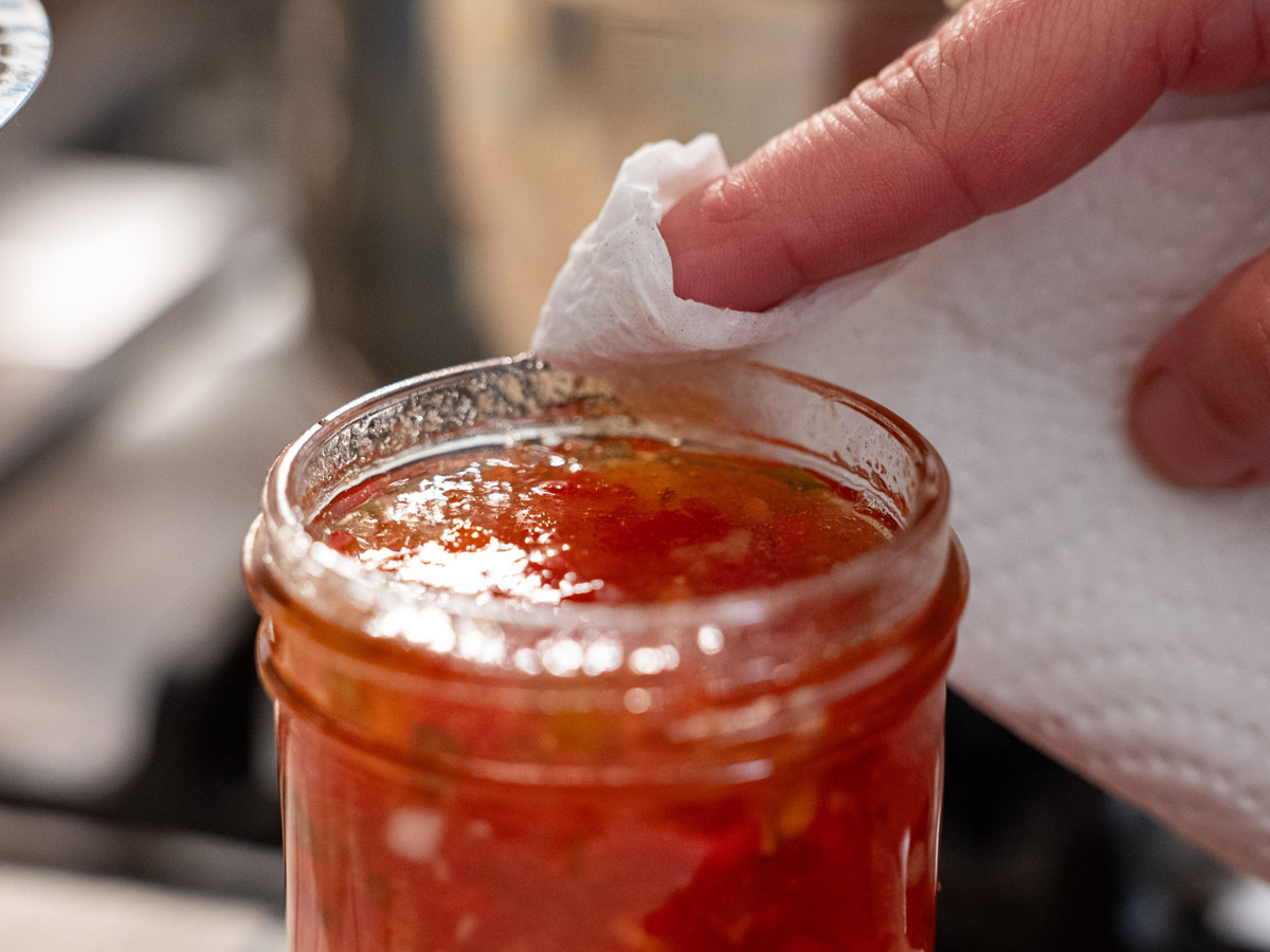 The rim of a jar being wiped clean.