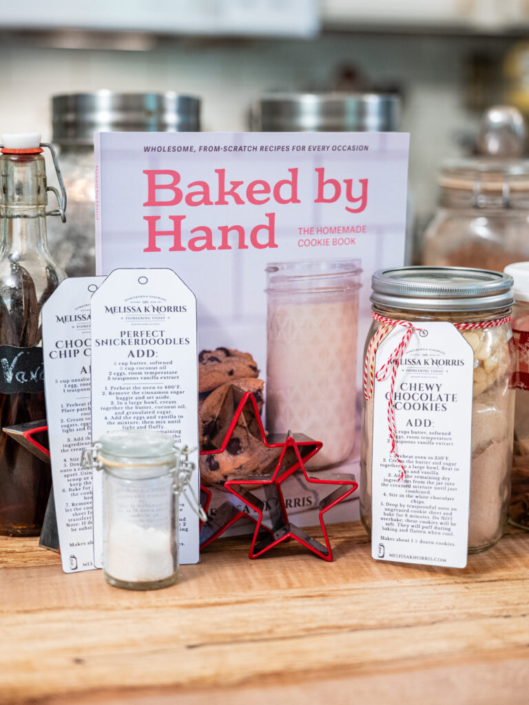 Baked by hand book next to jars of DIY mixes.