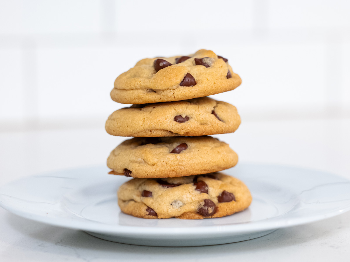 A stack of chocolate chip cookies on a plate.