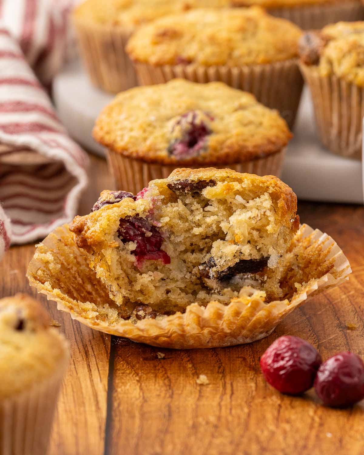 A bite out of an orange cranberry muffin.