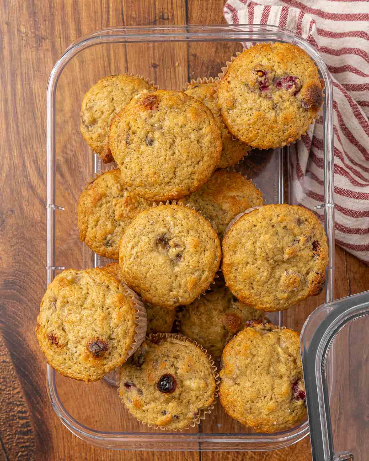 Cranberry muffins in a glass storage container.