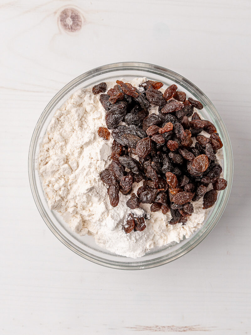 Raisins in a bowl of flour.