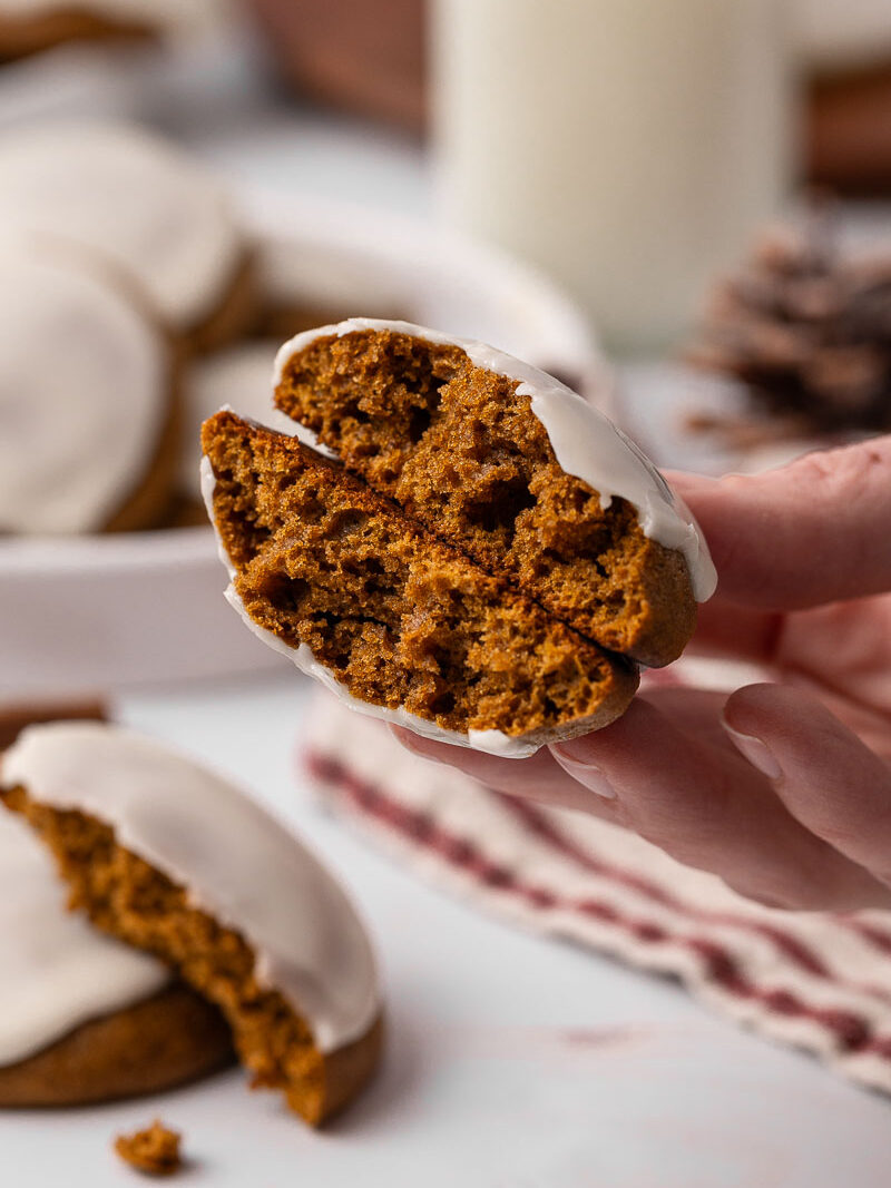 Ginger cream cookie broken in half.