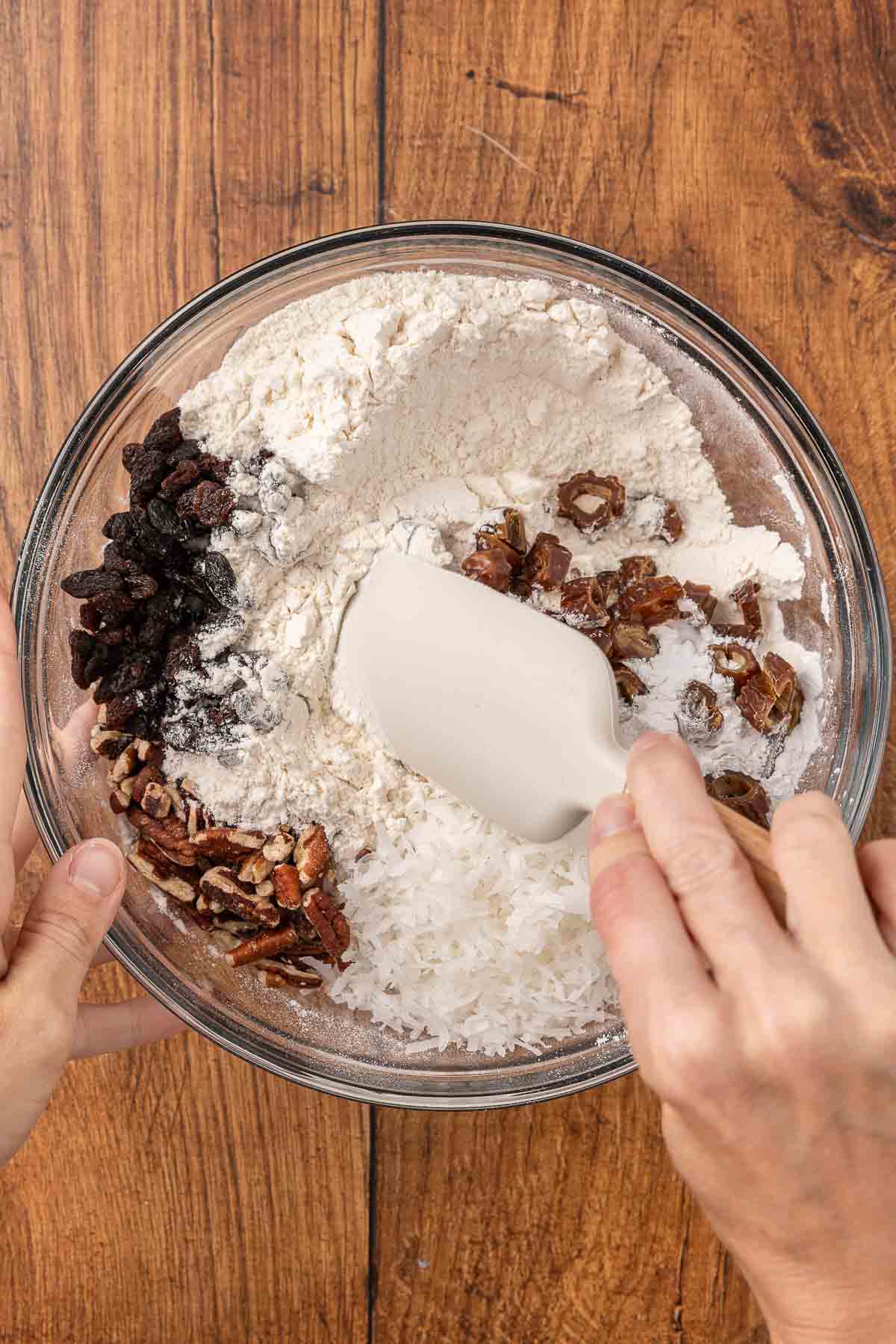 Stirring ingredients for cranberry muffins together in a bowl.