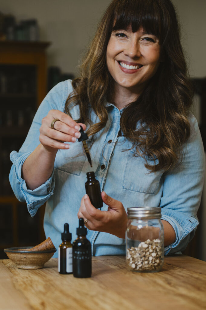 A woman holding a tincture.