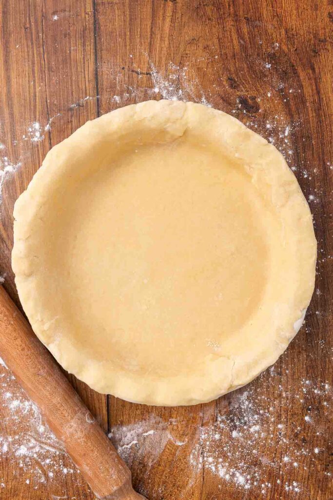 An unbaked pie crust inside a pie plate.