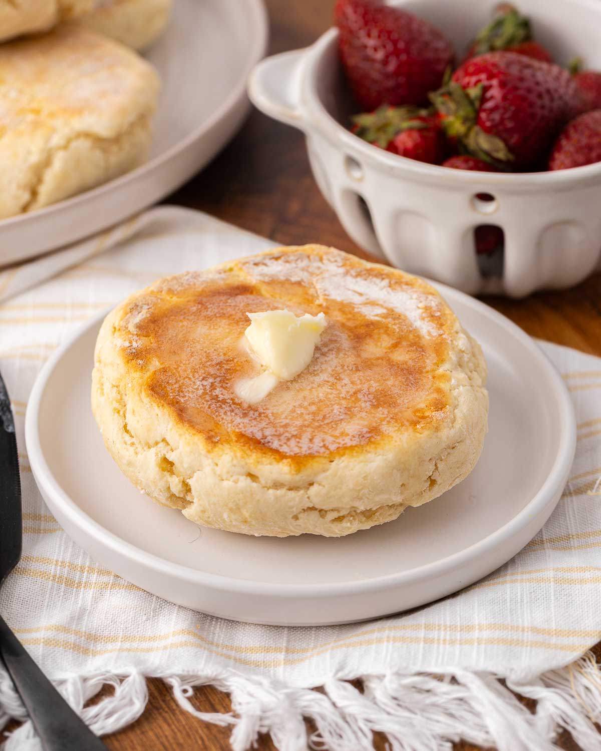 Potato bannock on a white plate with melty butter.
